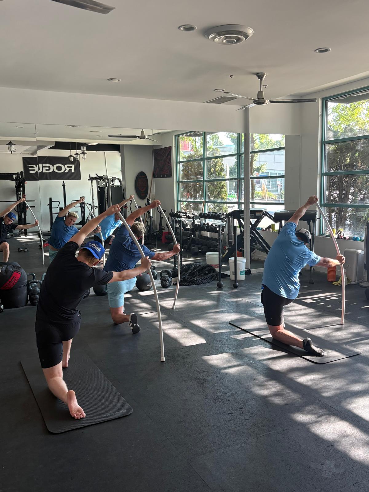 Hockey players training end-range hip and spine mobility on the turf
